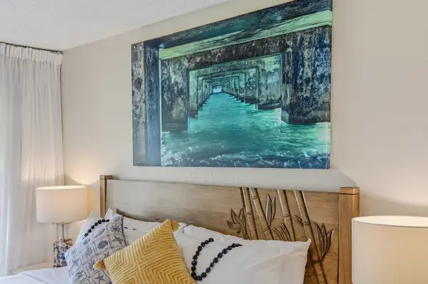 Bedroom wall artwork displayed directly above the bed