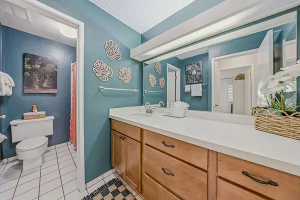 Bathroom vanity with large mirror & blue accent walls