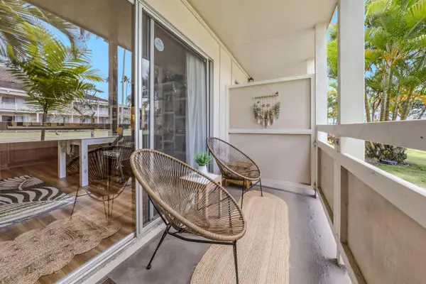 Private lanai with woven chairs, runner rug & privacy divider
