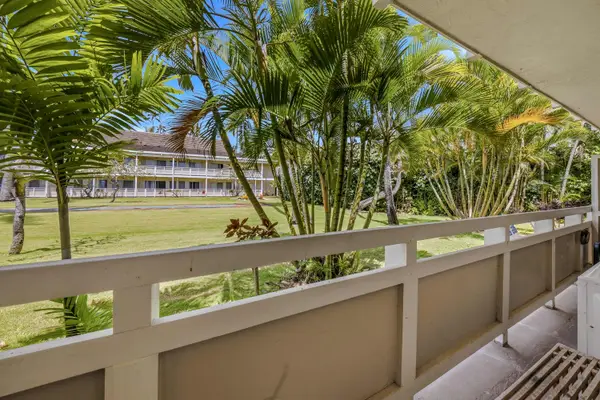 Lanai view overlooking lush tropical grounds and palms