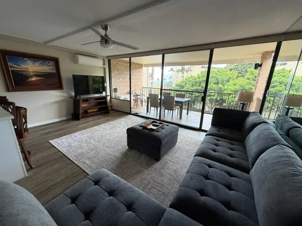 Open Living Room with Sectional Sofa & Covered Balcony Access