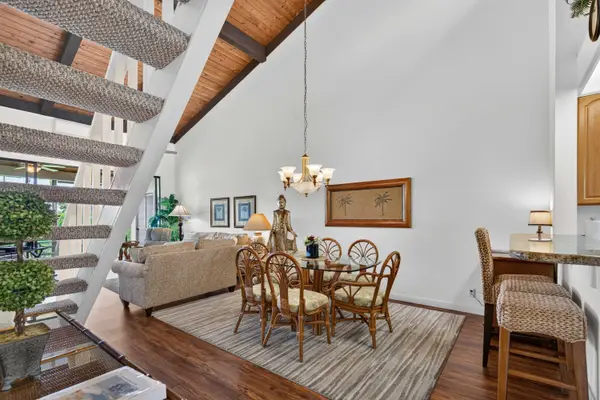 Dining area with wicker seating under vaulted ceilings