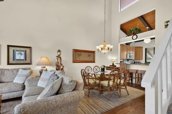 Open-concept living and dining area with high ceilings