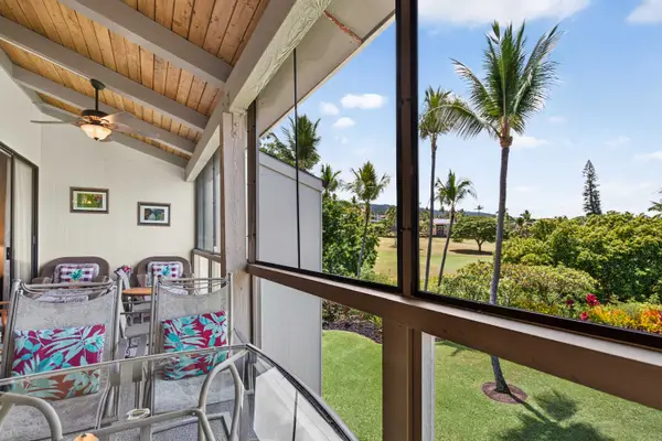 Screened lanai with outdoor seating and lush tropical views