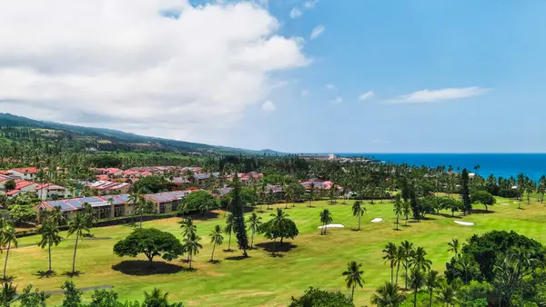 Panoramic view of golf course, resort grounds, and ocean coastline