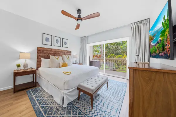 Master King Bedroom with Wood Headboard and Lanai Views