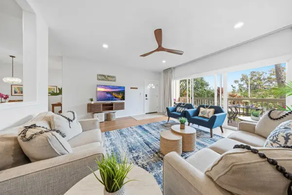 Spacious Living Room with Ceiling Fan and Garden Views