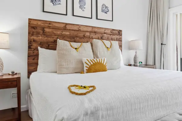 Cozy King Bed with Wood Headboard and Framed Art