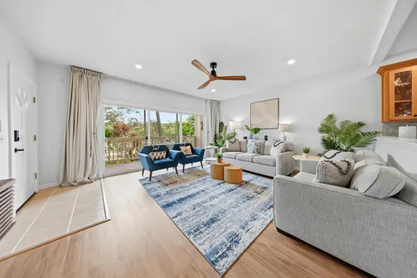 Bright Living Room with Balcony Access and Ocean Light