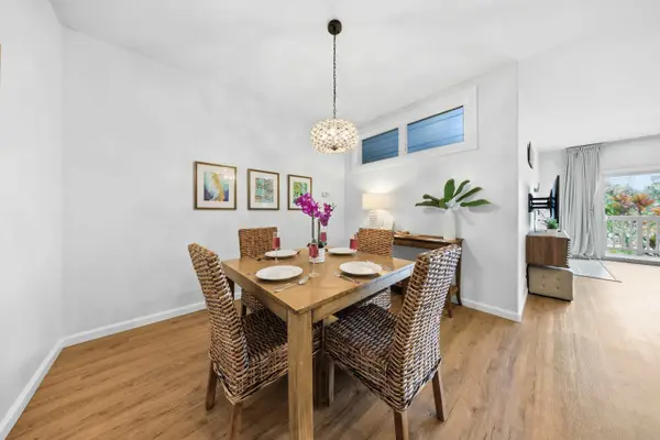 Elegant Dining Space with Pendant Light and Living Room Flow