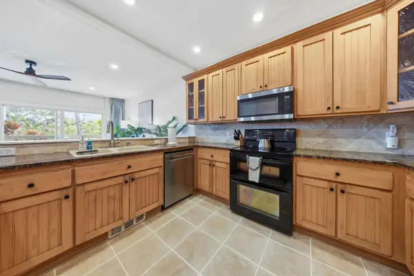 Spacious Kitchen with Granite Counters and Garden Views
