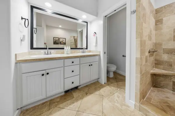 Vanity Bathroom with Framed Mirror and Walk-In Shower
