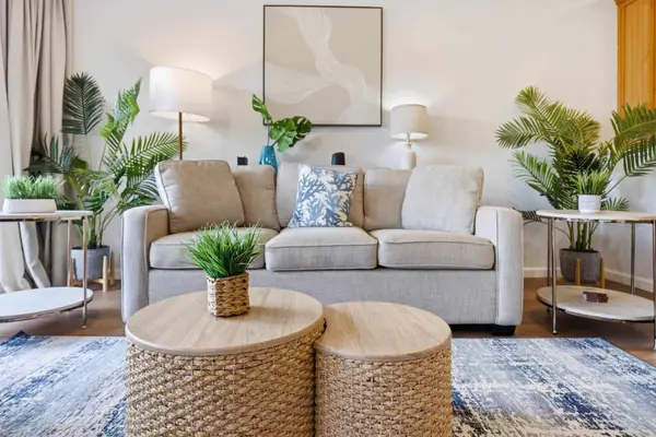 Cozy Living Room with Rattan Coffee Tables and Greenery