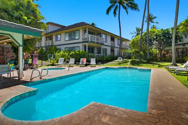 Turquoise Pool with Palm Trees and Lounge Chairs