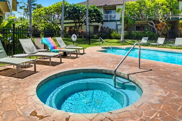 Round Hot Tub Beside the Community Pool and Loungers