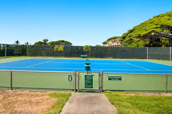 Fenced Tennis Court with Hillside Backdrop