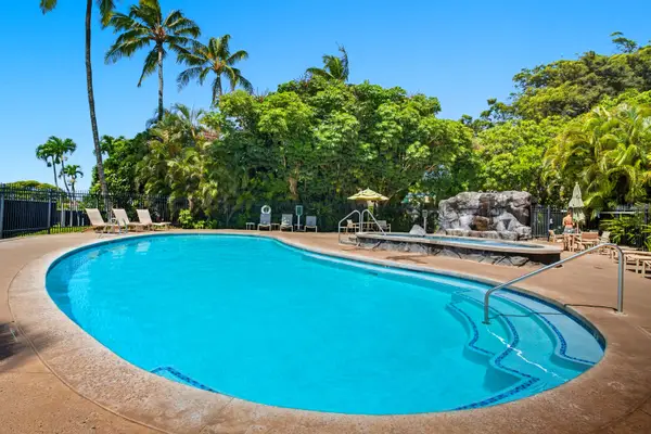 Curved Community Pool with Rock Waterfall and Palms