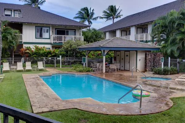 Community Pool with Covered Cabana and Palm Trees