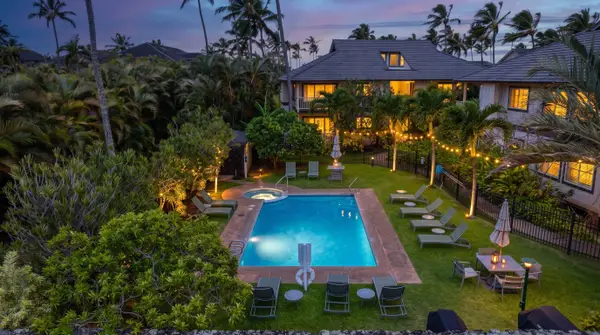 Twilight View of the Estate with Glowing Pool and String Lights