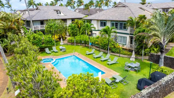 Community Pool Surrounded by Buildings and Tropical Palms