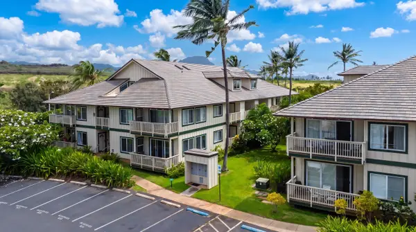 Building Exterior with Balconies and Palm Tree Landscaping