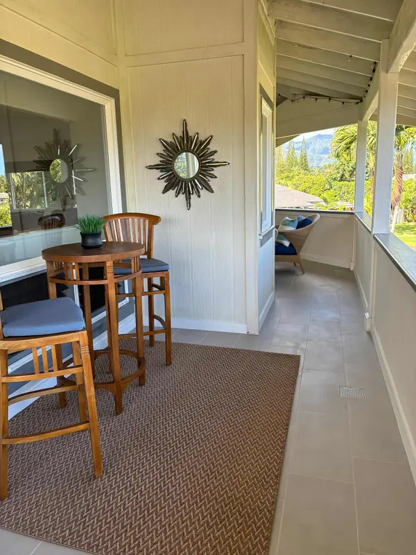 Covered balcony walkway featuring bistro seating & outdoor views