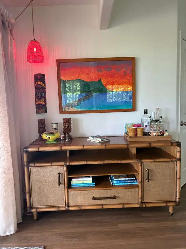Woven wood credenza setup with accent light & wall decor