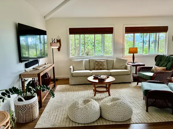 Bright and comfortable living room with plenty of seating and TV