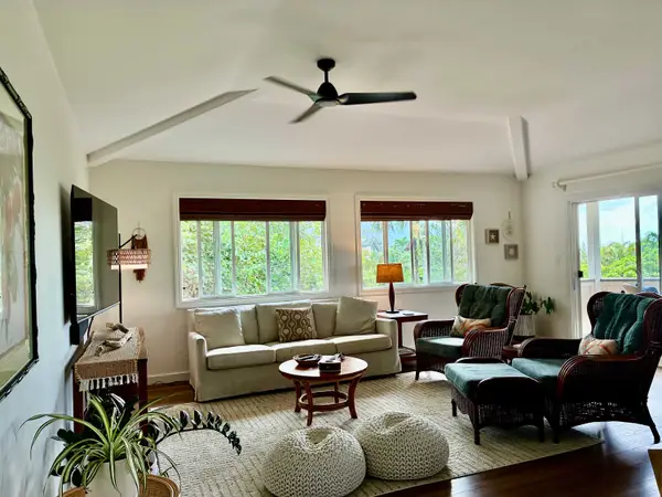 Bright and comfortable living room with plenty of seating and TV
