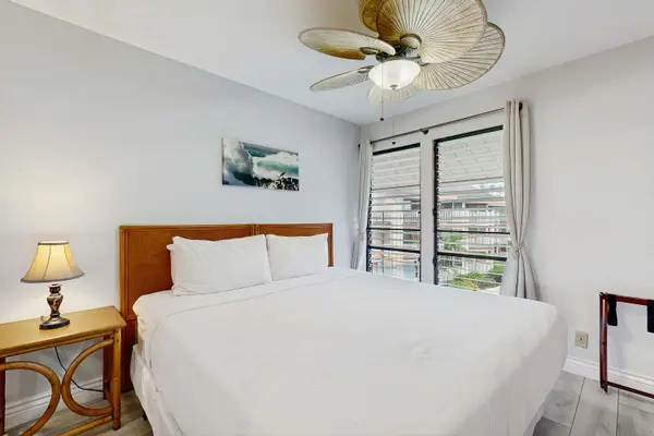 Sunlit King Guest Bedroom Retreat Featuring Custom Woven Ceiling Fan and AC