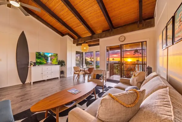 Sunset lit living room and dining area with lanai view