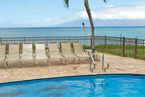 Hololani Resort community pool - amazing pool, swaying palm trees and steps to the ocean.