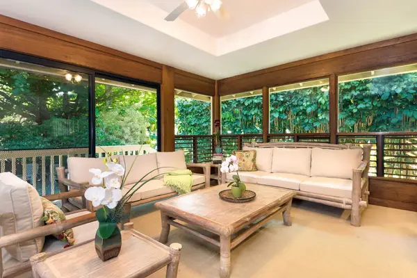 Bright living area offers sofas, artwork, windows, and wood details