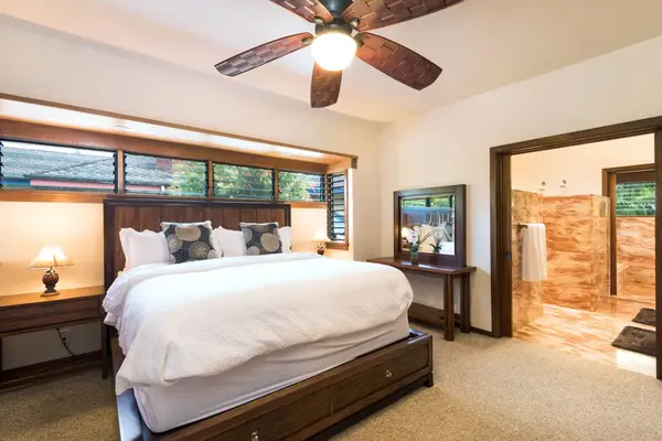 Spacious bedroom presents a king bed, wood accents, and natural light