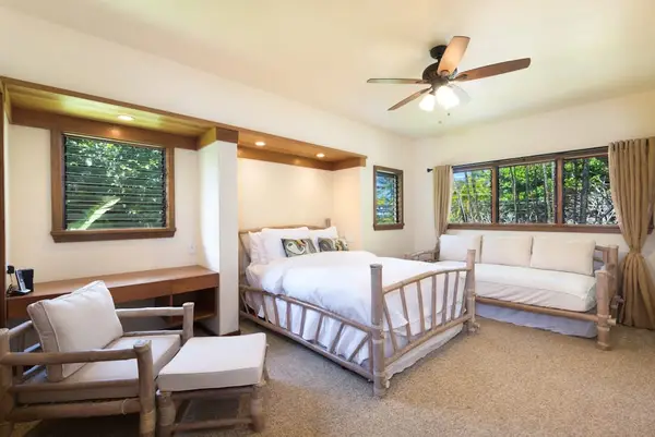 Relaxing bedroom combines soft linens, wood details, and scenic windows