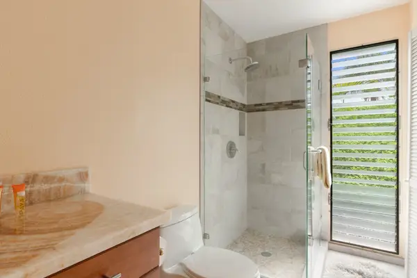 Modern Glass-Enclosed Walk-In Shower with Tiled Walls