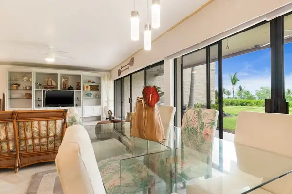 Sunlit Dining Area with Scenic Views Through Large Glass Doors