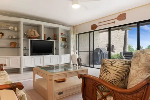 Bright Living Area with Large Windows & Media Center