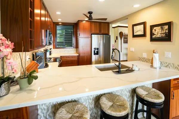 Three barstools for extra seating at the kitchen.