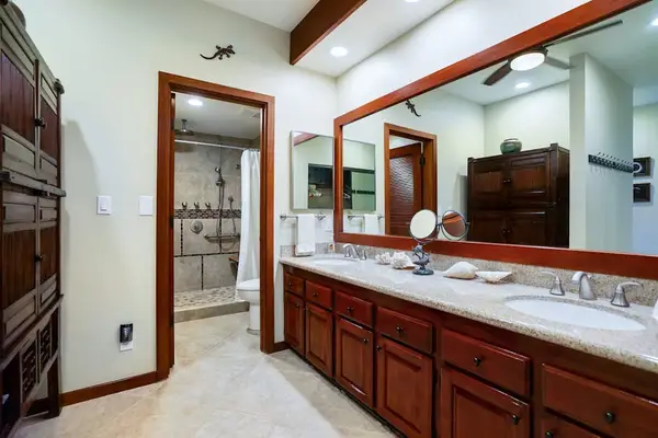Master shower with double sinks and a large tiled walk-in shower.