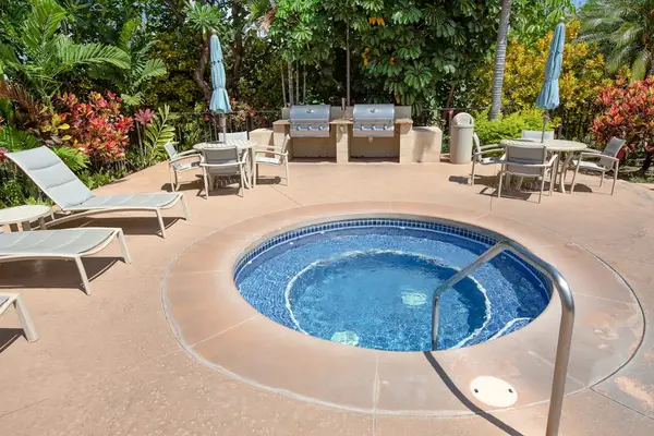 Soak and relax in the inviting poolside hot tub