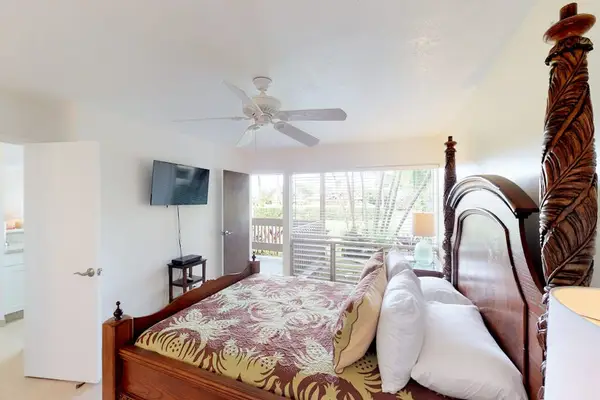 Master bedroom with king bed and flat screen tv.