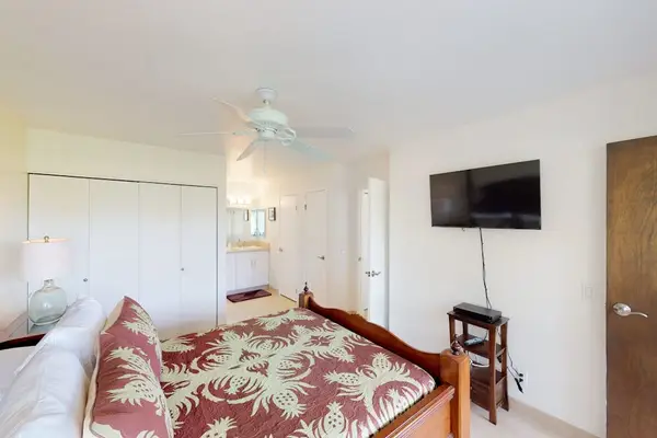 Master bedroom with king bed and a flat screen tv.