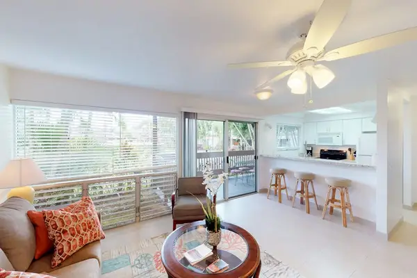 Living room open to the kitchen and the lanai.
