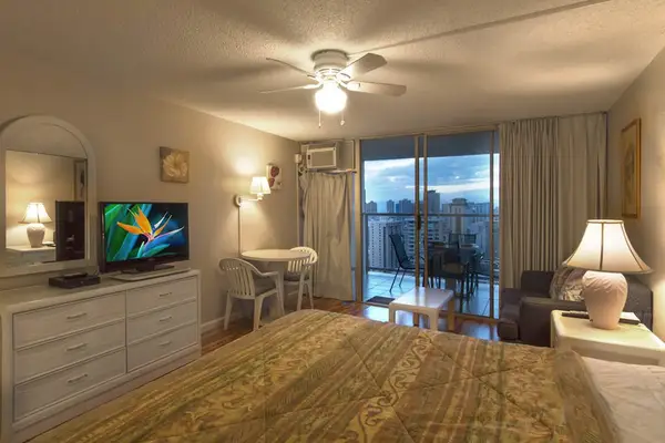 Relax in this inviting studio featuring a comfortable king bed and convenient access to a private balcony.