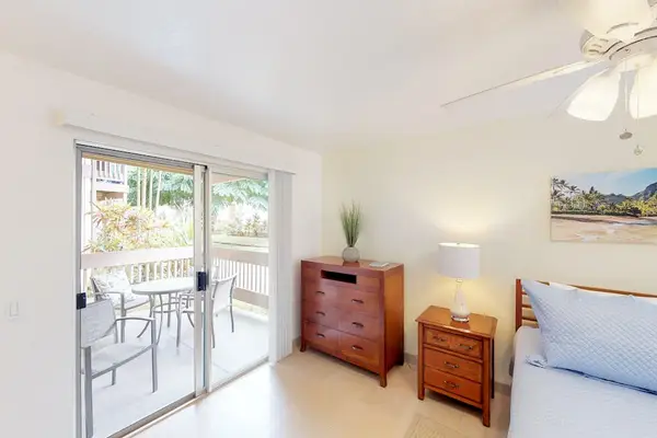 Guest room with queen bed, flat screen tv and lanai access.