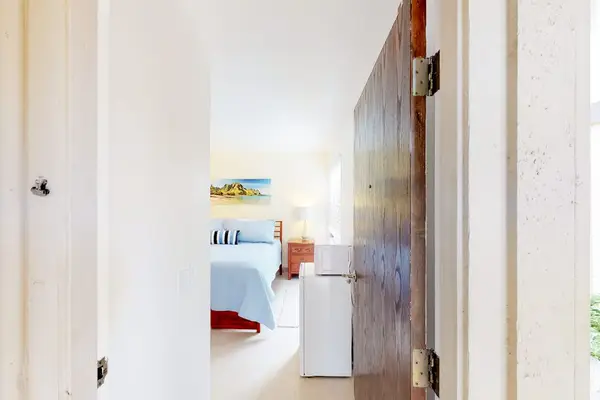 Guest room with queen bed, flat screen tv and lanai access.