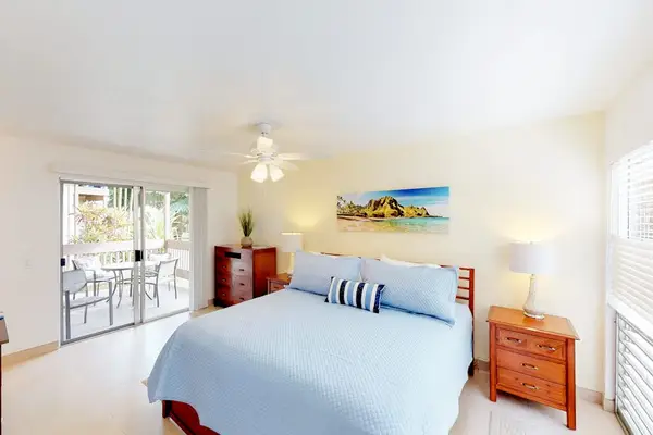 Guest room with queen bed, flat screen tv and lanai access.