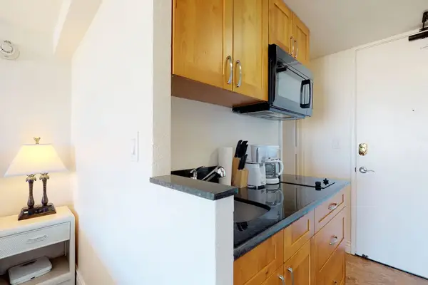 Compact kitchenette equipped for light meals and morning coffee.