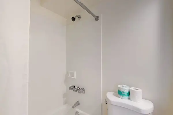 Clean and functional bathroom with a tub and shower combination.